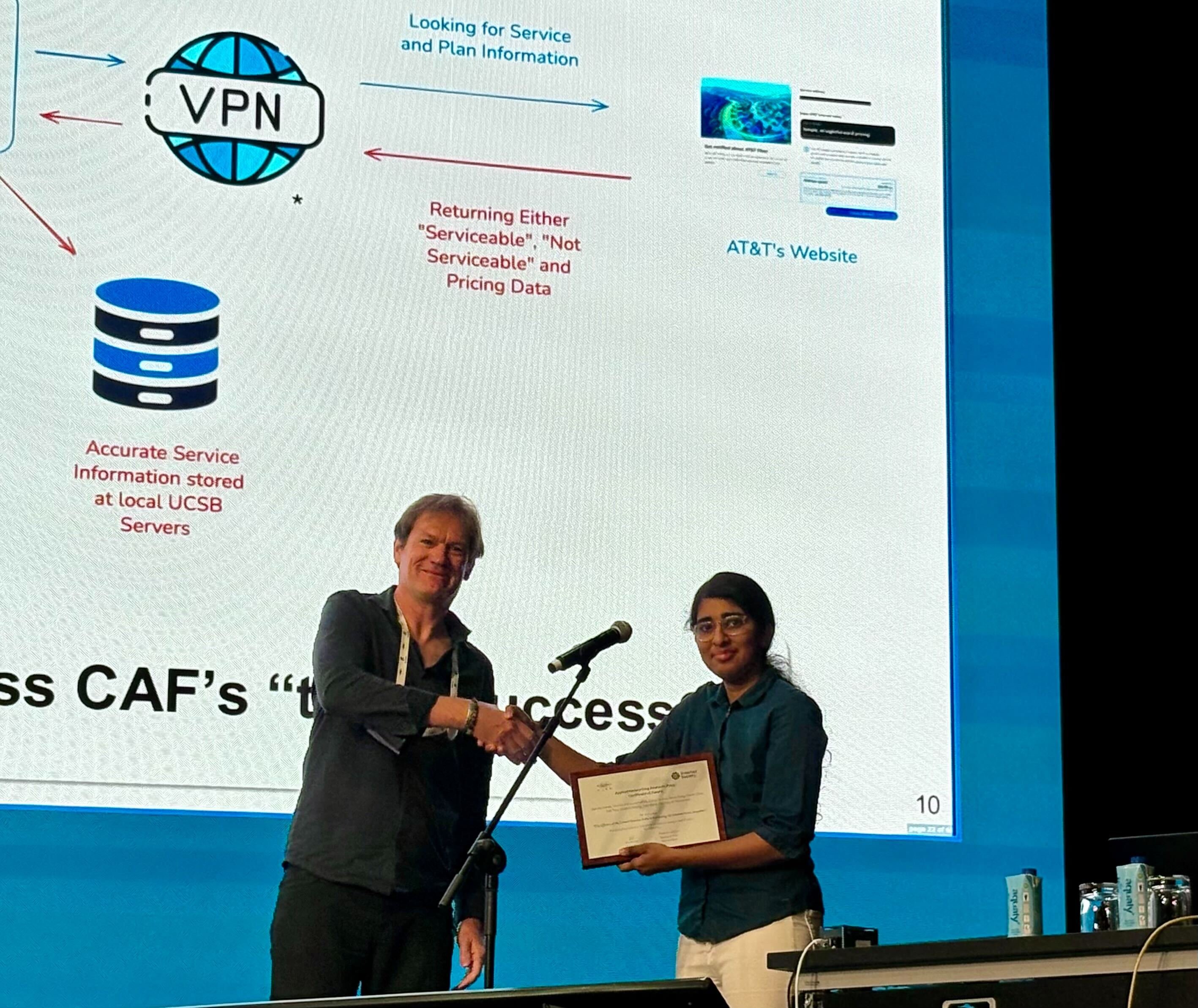 Haarika Manda receives the Applied Networking Research Prize from IRTF Chair Dirk Kutscher during the IRTF Open session at IETF 123.